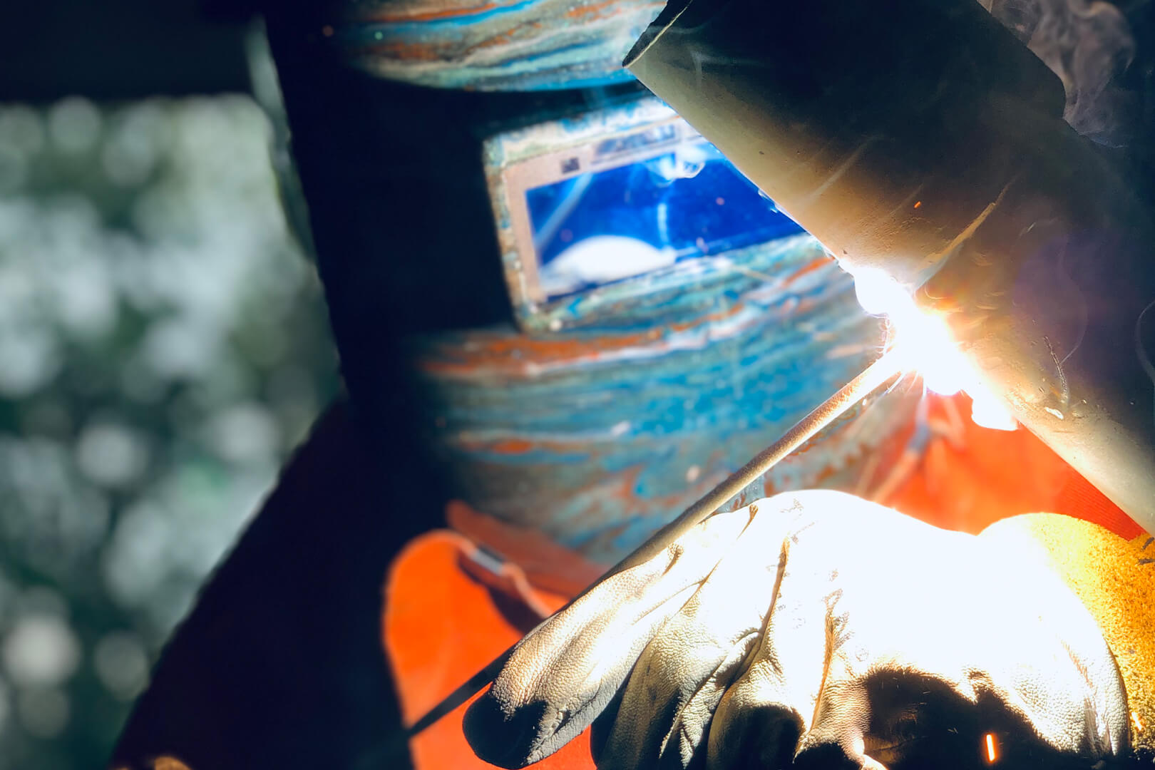 A person welding a pipe