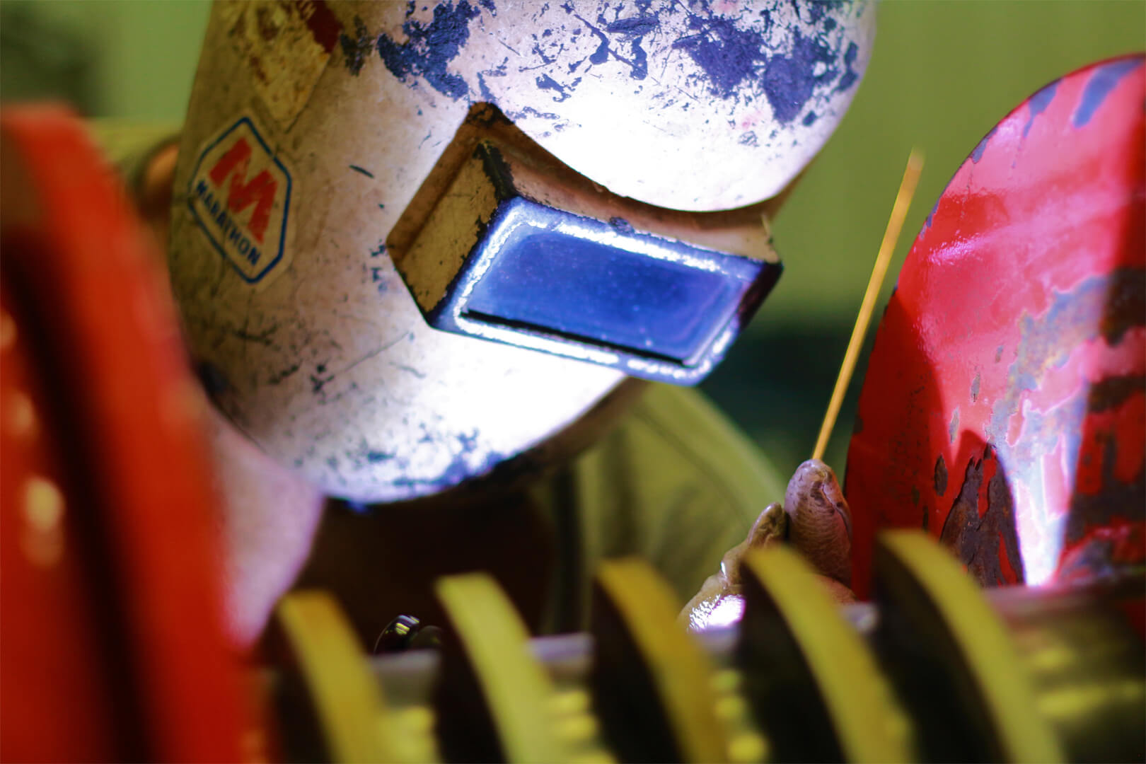 A person wearing a welding helmet